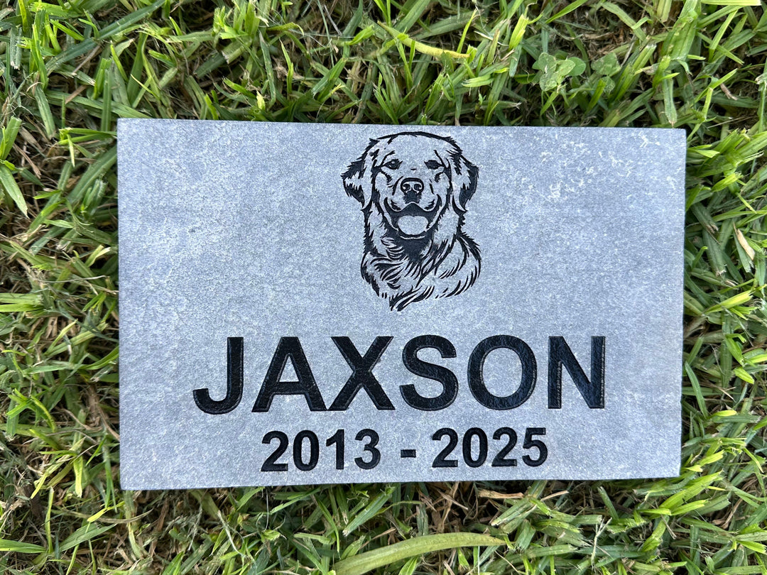 Memorial plaque for a dog named Jaxson on grass