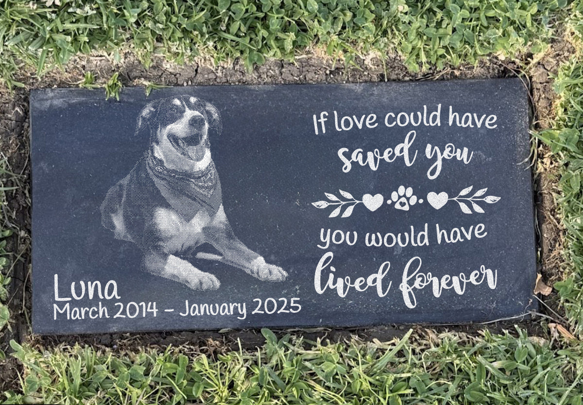 Large flat black granite pet headstone installed level with grass