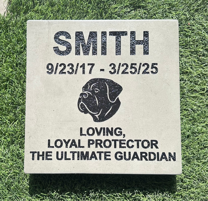 Memorial stone for a dog named Smith on grass