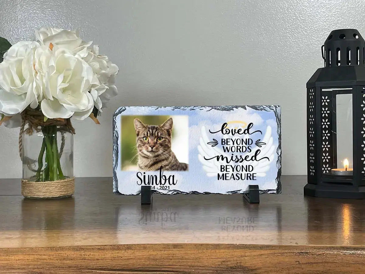 Compact cat memorial slate for Simba displayed on a tabletop beside flowers and a lantern