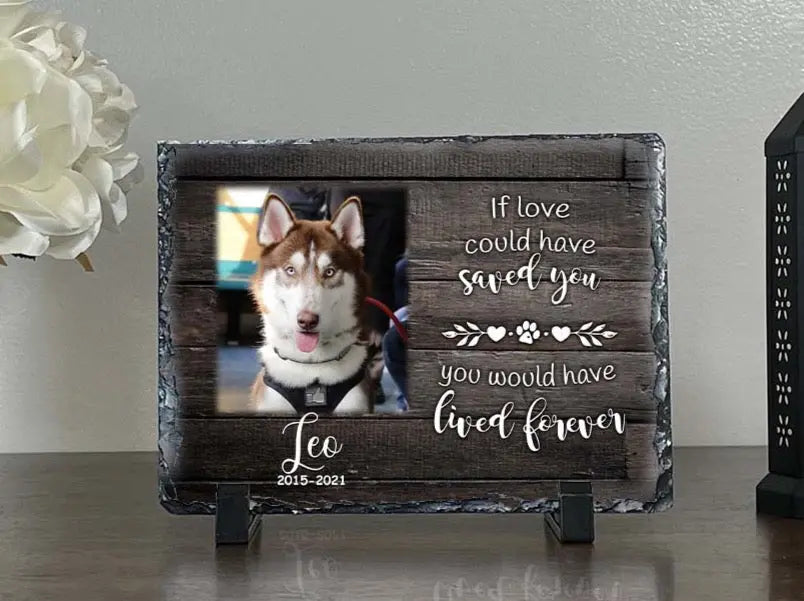 Personalized dog memorial slate for Leo displayed on a tabletop with dark wood design
