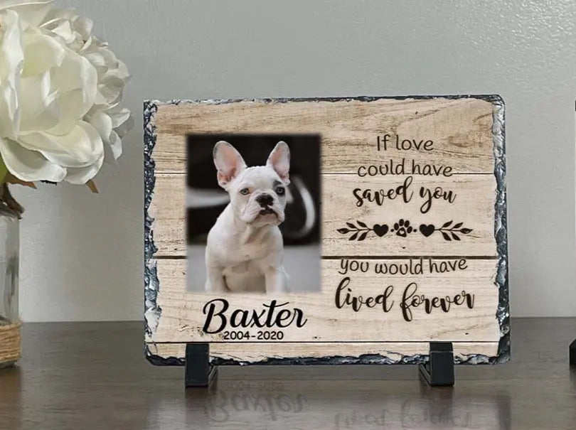 Small light-wood dog memorial photo slate for Baxter displayed on black stands