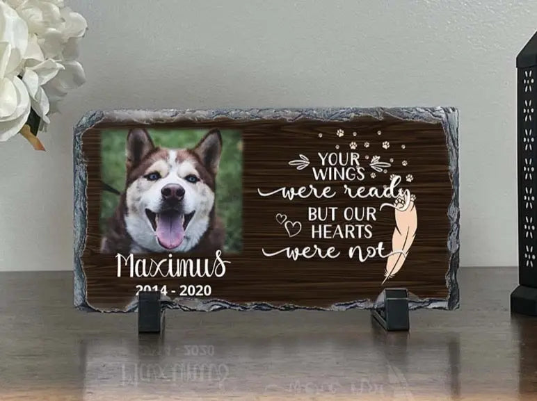 Personalized dog memorial slate for Maximus displayed between white flowers and a candle lantern